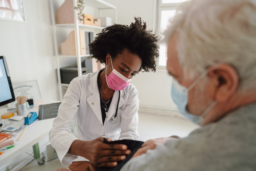 Doctor checking the patients blood pressure