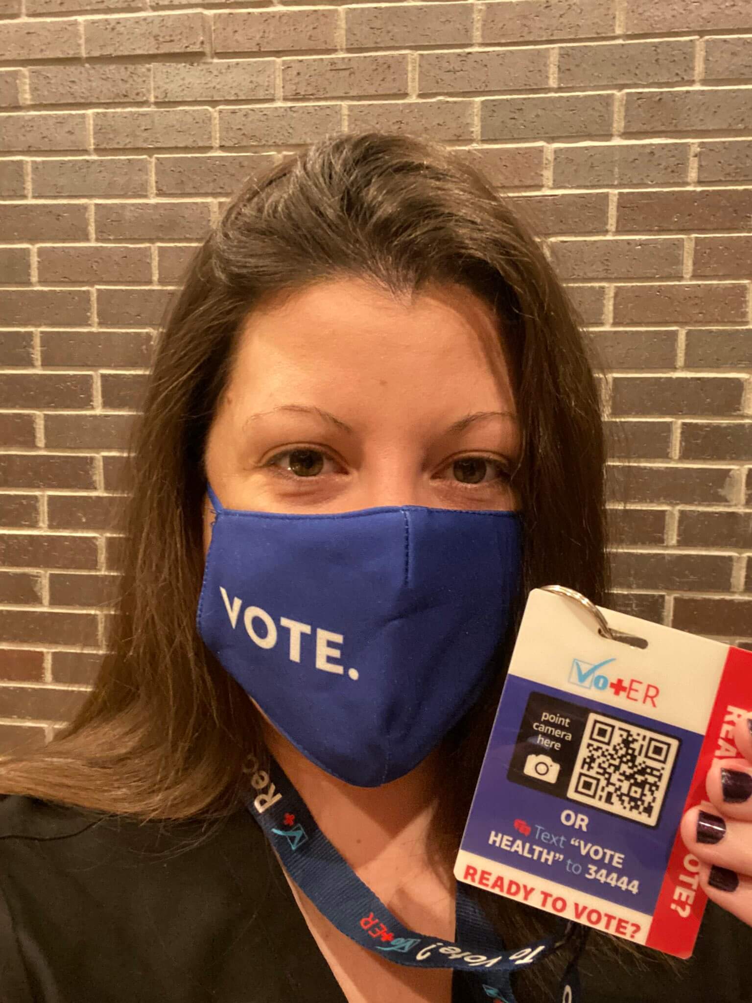 Jennifer Caputo with Vot ER badge and vote mask