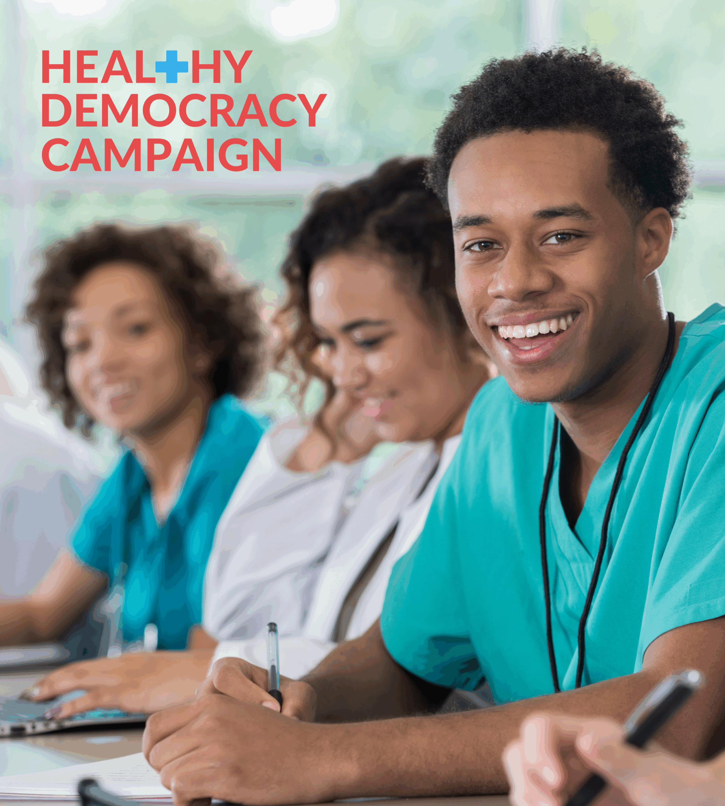 3 medical students sitting at a table smiling